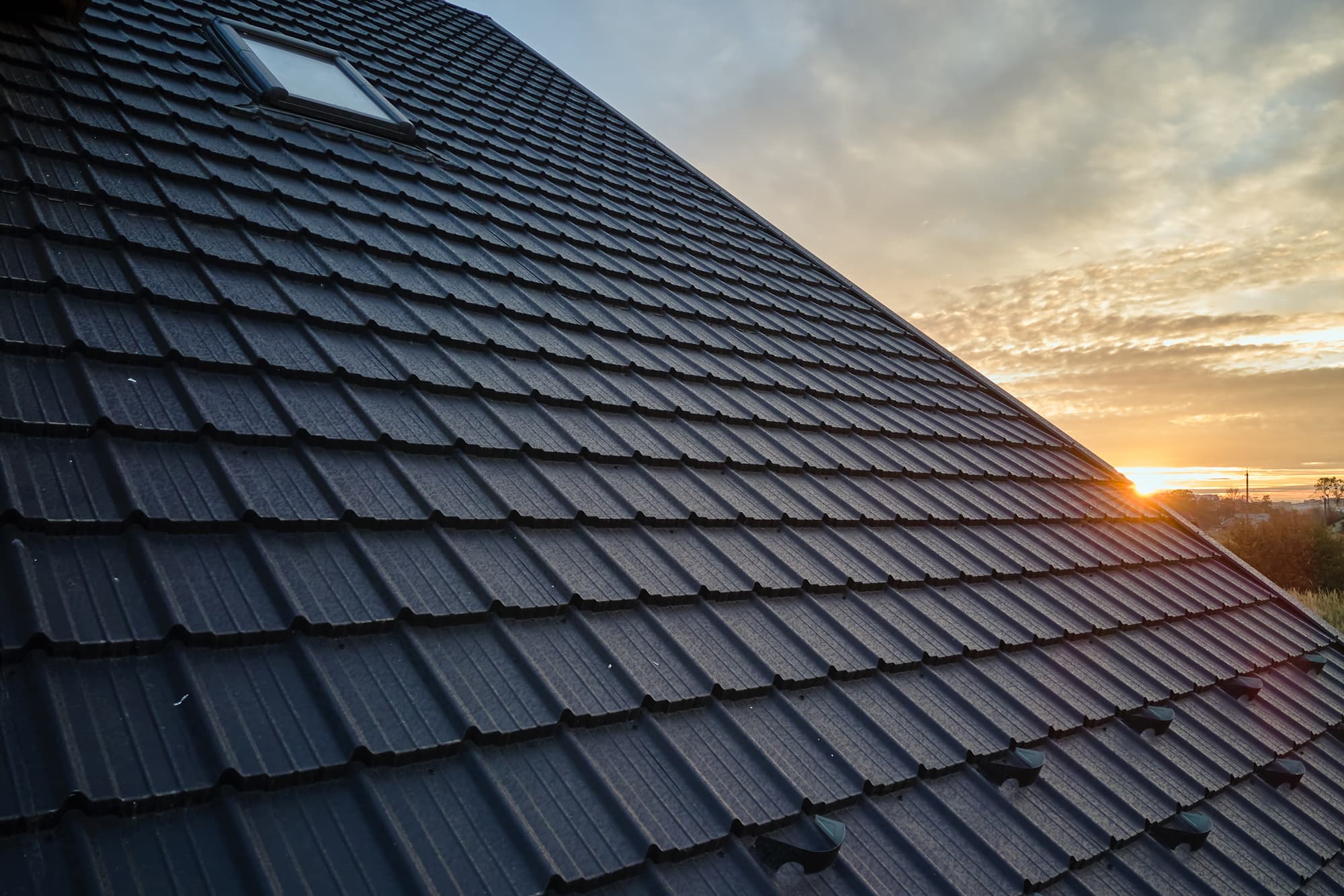 Roofing project — dark tile at sunset